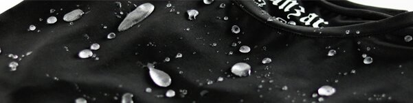 Water-resistant black workwear fabric with water droplets, showcasing durability and quality.