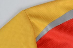 High-visibility safety vest fabric with yellow, red, and gray reflective strips, designed for workwear uniforms, ensuring safety and durability for industrial and construction environments.