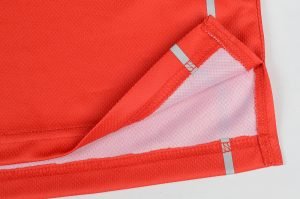 Bright orange high-visibility safety vest with reflective strips and durable fabric for industrial work environments. Customizable workwear designed for safety and comfort.