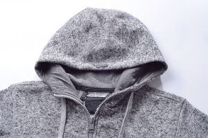 Soft gray hoodie with adjustable drawstrings and full zipper, made from comfortable knit fabric ideal for casual wear and outdoor activities. Perfect for custom branding and uniforms.
