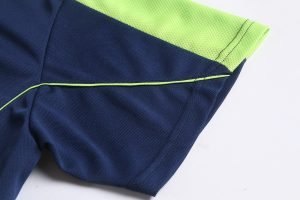 Bright navy blue and neon green custom work uniform fabric close-up, showcasing durable textiles and professional design for industrial and industrial workwear applications.