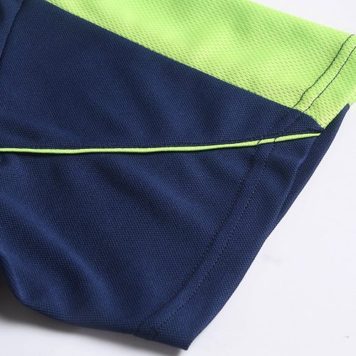 Bright navy blue and neon green custom work uniform fabric close-up, showcasing durable textiles and professional design for industrial and industrial workwear applications.