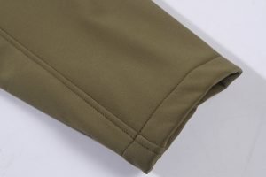 Viewport of khaki-colored custom workwear fabric with neat stitching and folded edge.