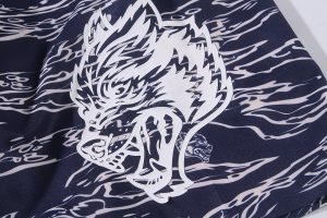 High-quality custom fabric with bold white dragon graphic print on navy background, ideal for workwear uniforms, showcasing craftsmanship and unique design for personalized clothing.