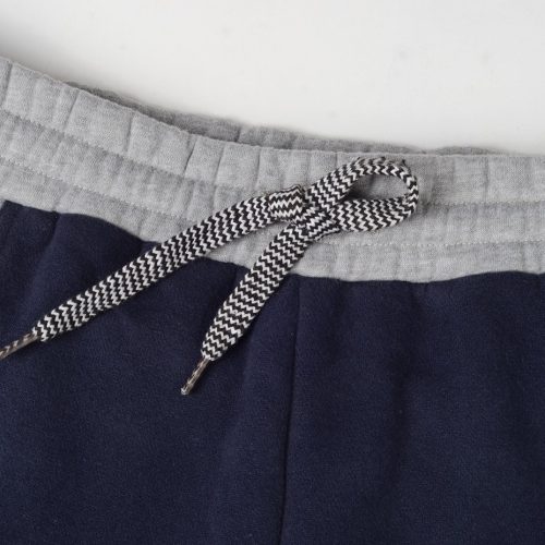 Soft grey and navy drawstring waistband detail of custom sportswear, highlighting comfortable fabrication and tailored fit for workwear uniforms.