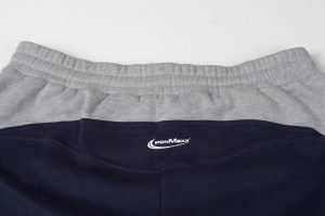 Soft grey and black athletic shorts with elastic waistbands, featuring the Iron Maxx logo, designed for comfort and activewear needs. Ideal for sports, gym, or casual wear.
