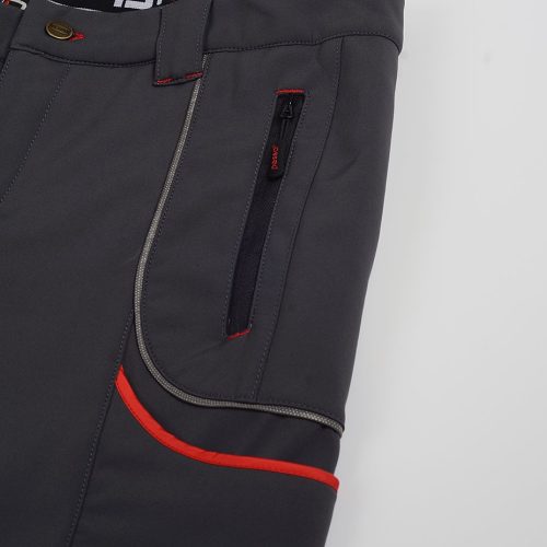 Black workwear pants with red accents, multiple pockets, and durable zippers for industrial and professional use. Designed for comfort and practicality in tough work environments.