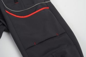 Durable black work pants with red accents, designed for comfort and functionality in various industrial and construction settings. Perfect for custom apparel needs.
