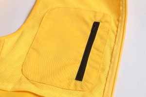Bright yellow workwear backpack with a durable black zipper pocket for professional custom uniforms and safety gear. Designed for comfort and practicality in industrial environments.