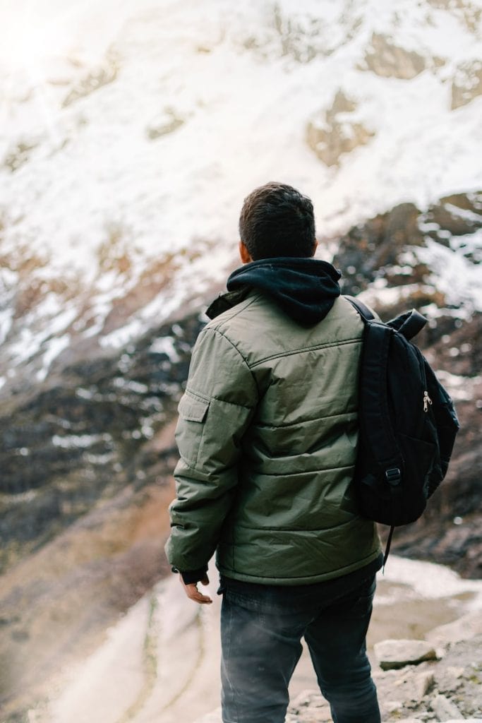 Warm winter men's jacket with hoodie, suitable for outdoor hiking and cold weather adventures.