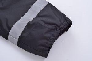 High-quality black workwear pants with reflective silver stripes, ideal for industrial safety and professional uniforms. Durable fabric designed for comfort and visibility.