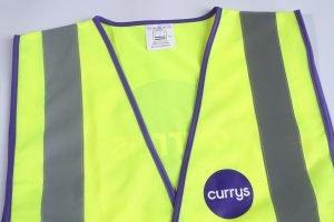 High-visibility safety vest with reflective stripes and purple trim, designed for workwear and visibility on construction sites or industrial environments.