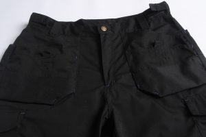 Black tactical work pants with multiple pockets, durable fabric, and adjustable waistband, ideal for industrial and outdoor work environments. Customizable for various workwear needs.