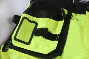 High-visibility safety work pants with reflective strips and multiple pockets for durability and functionality. Suitable for construction, roadside, and industrial workers.