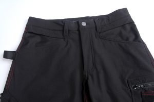 Black work pants with multiple pockets and red stitching, designed for durability and comfort in industrial environments. Perfect for custom uniforms and workwear needs.