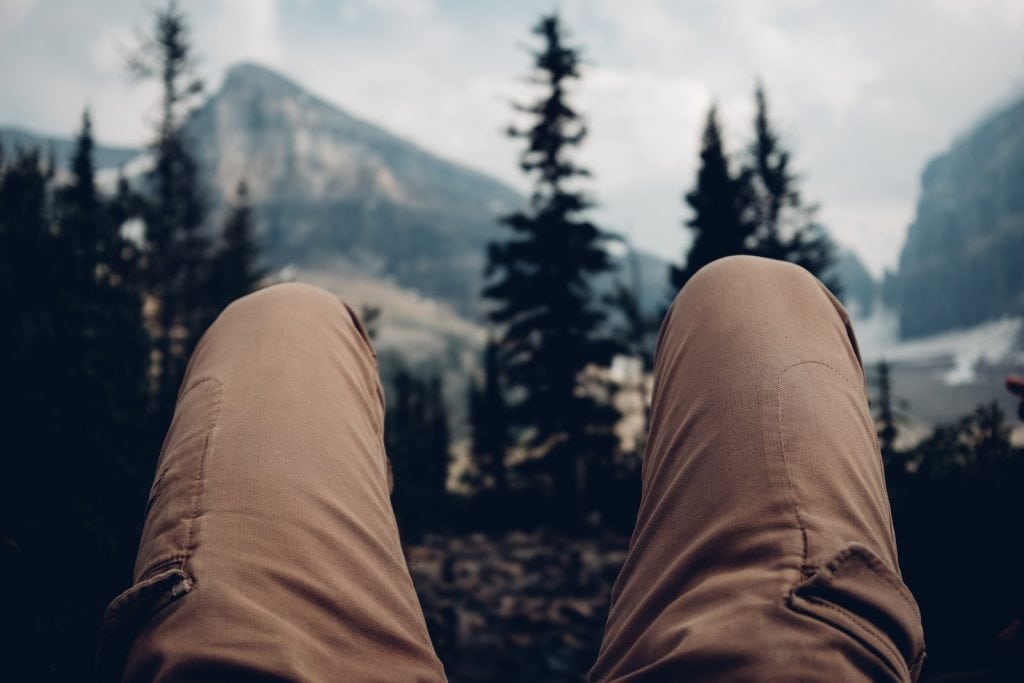 Comfortable beige work pants in an outdoor mountain setting, ideal for outdoor workers and adventurers.