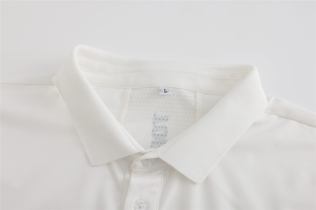 Close-up of a white polo shirt collar and button placket for front-of-house staff