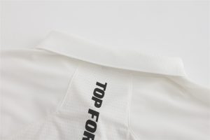 High-quality white workwear polo shirt with black printed logo, designed for durability and comfort, ideal for uniforms in industrial, hospitality, or corporate settings. Suitable for customization.