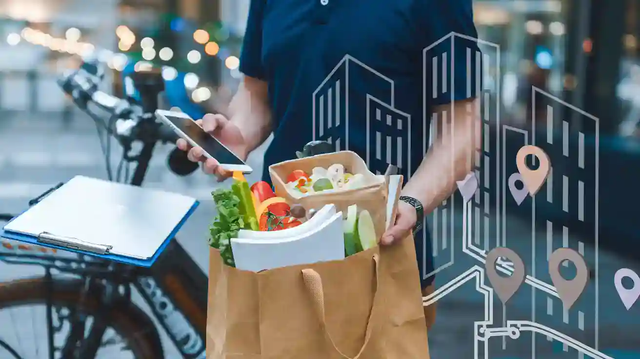Fresh vegetable meal in a paper bag held by a delivery worker wearing a work uniform on a city street.