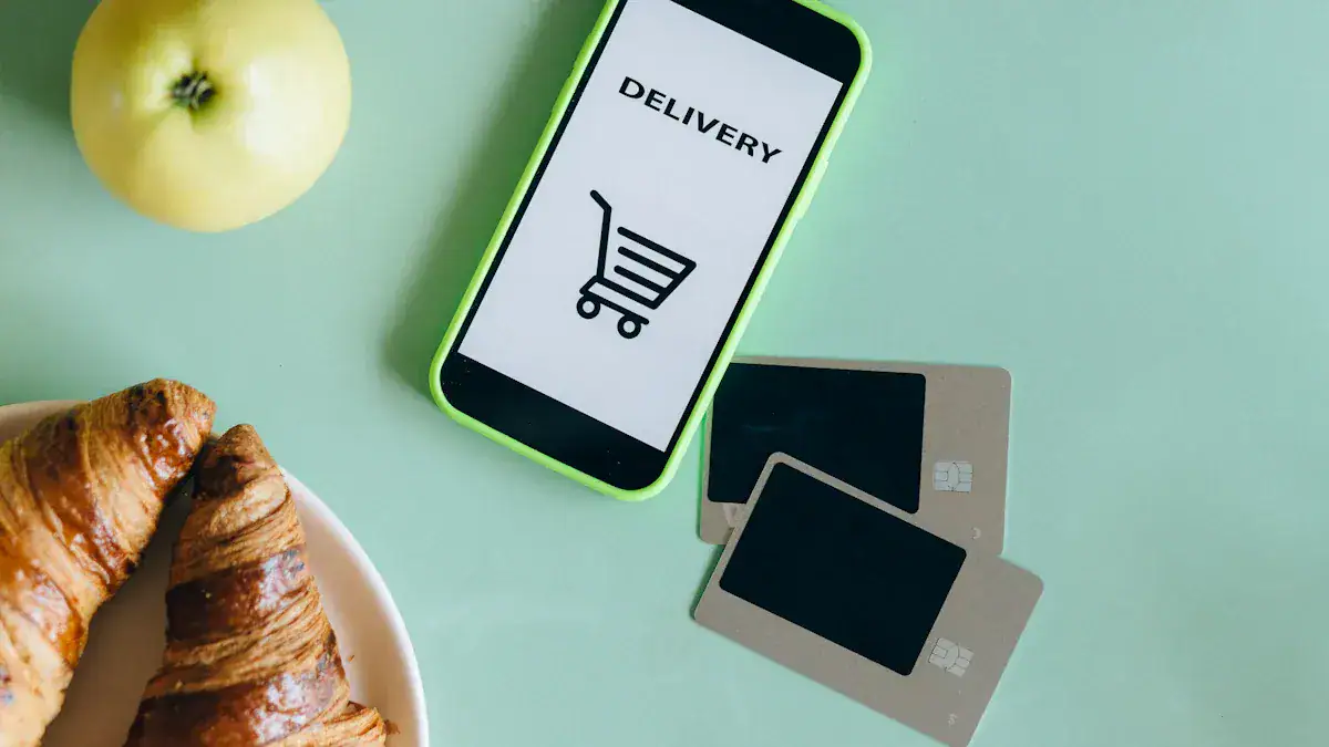 Apple iPhone with delivery app on screen, credit cards, and breakfast croissants on pastel background, illustrating online shopping and fast delivery.
