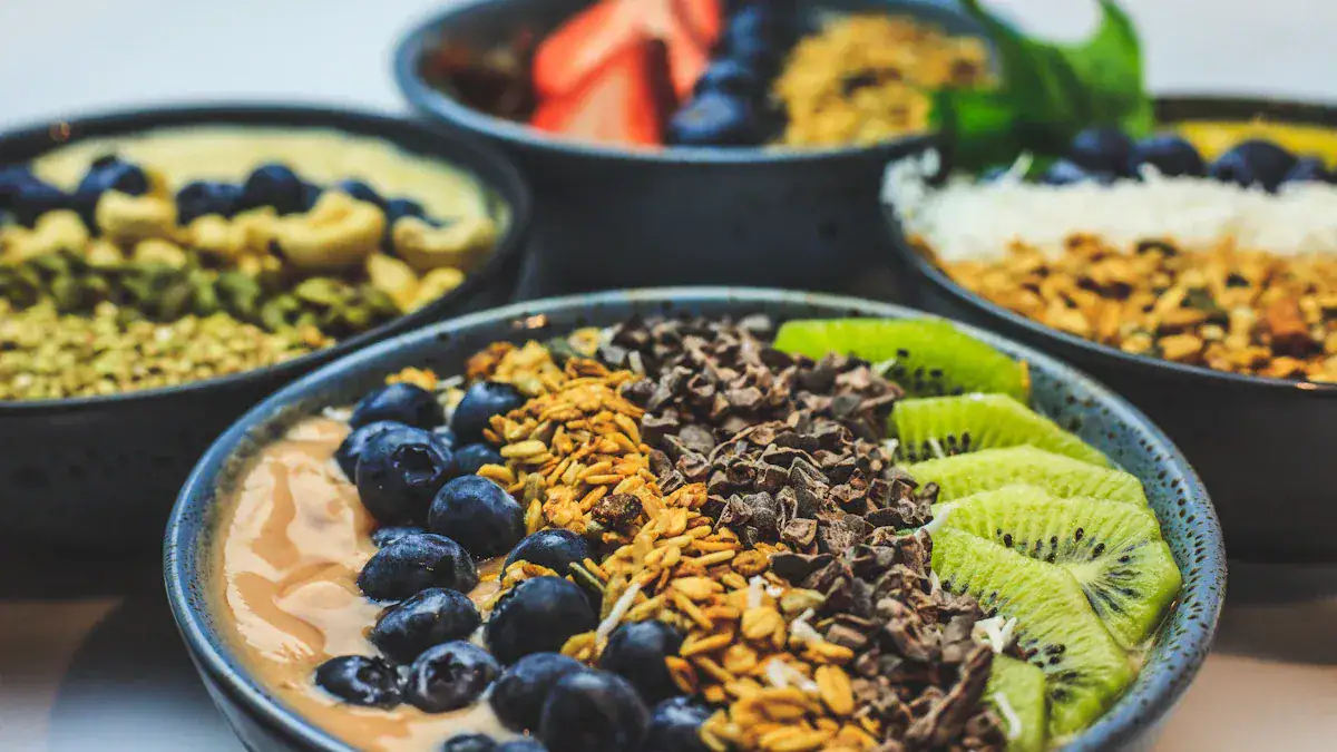 Blueberry smoothie bowl with granola and kiwi slices, healthy breakfast, vibrant colorful fruit, nutritious snack, close-up of fruit toppings and fresh ingredients in bowls.