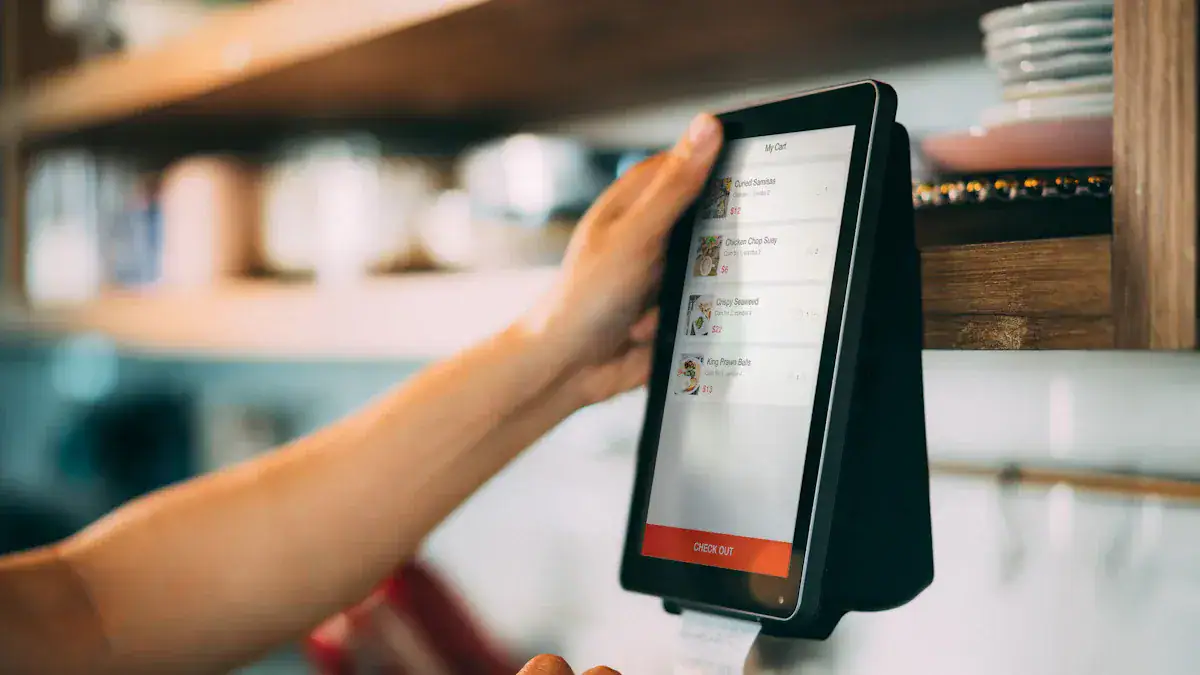 Custom online ordering payment device at a restaurant checkout counter.