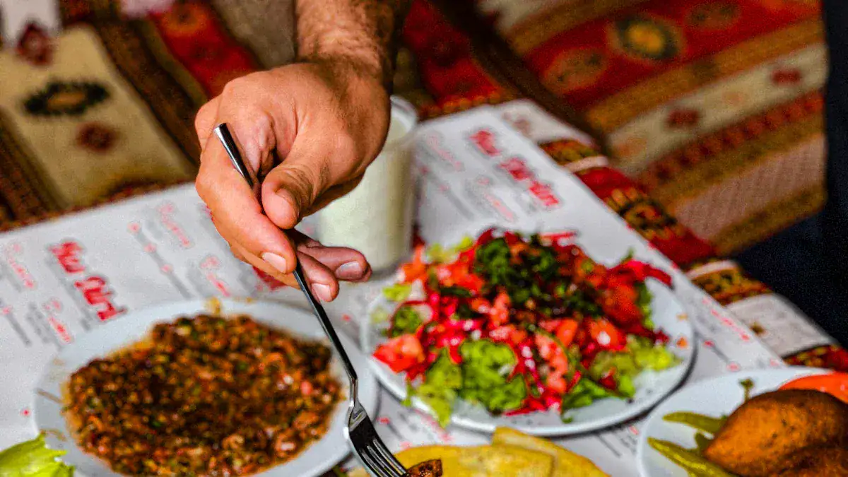 Fresh vegetable salad with colorful tomatoes and greens served on a restaurant table with traditional patterned textiles.