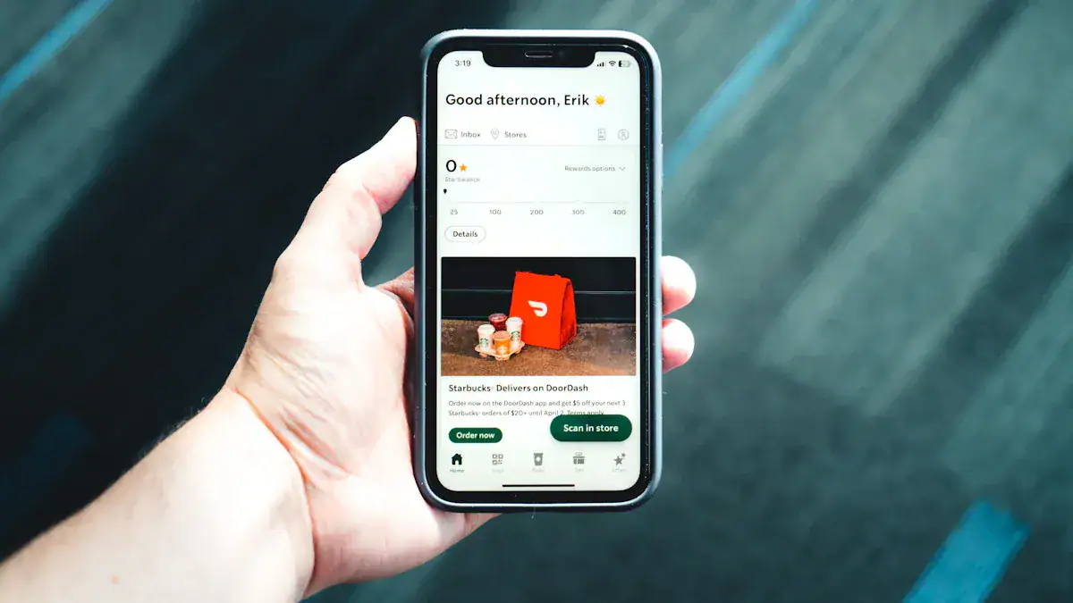 A person holding a smartphone displaying a DoorDash order confirmation screen with Starbucks products, showcasing modern mobile ordering and delivery services.