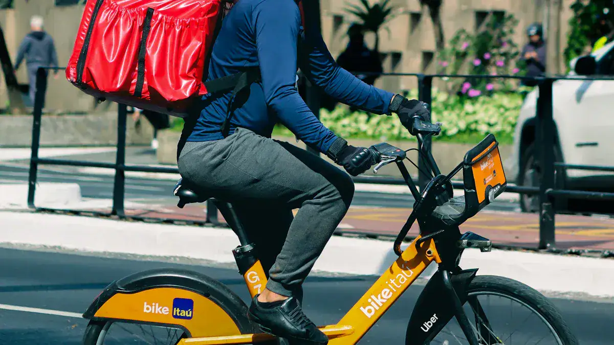 High-quality bike courier in casual uniform riding an electric bike in urban city street.