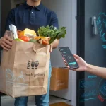 A person receives a grocery delivery at the door with digital security and smart technology graphics overlay.