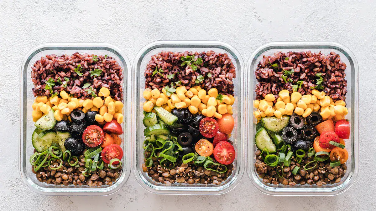 Colorful healthy vegan meal prep bowls with chopped vegetables, corn, cherry tomatoes, olives, greens, and lentils in glass containers.