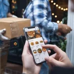 Delicious pizza menu showing on a smartphone screen held by a person during food delivery at night.