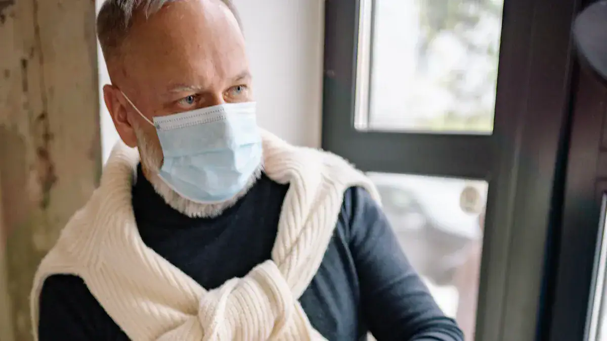 Medical professional wearing a protective face mask indoors, emphasizing safety and hygiene.