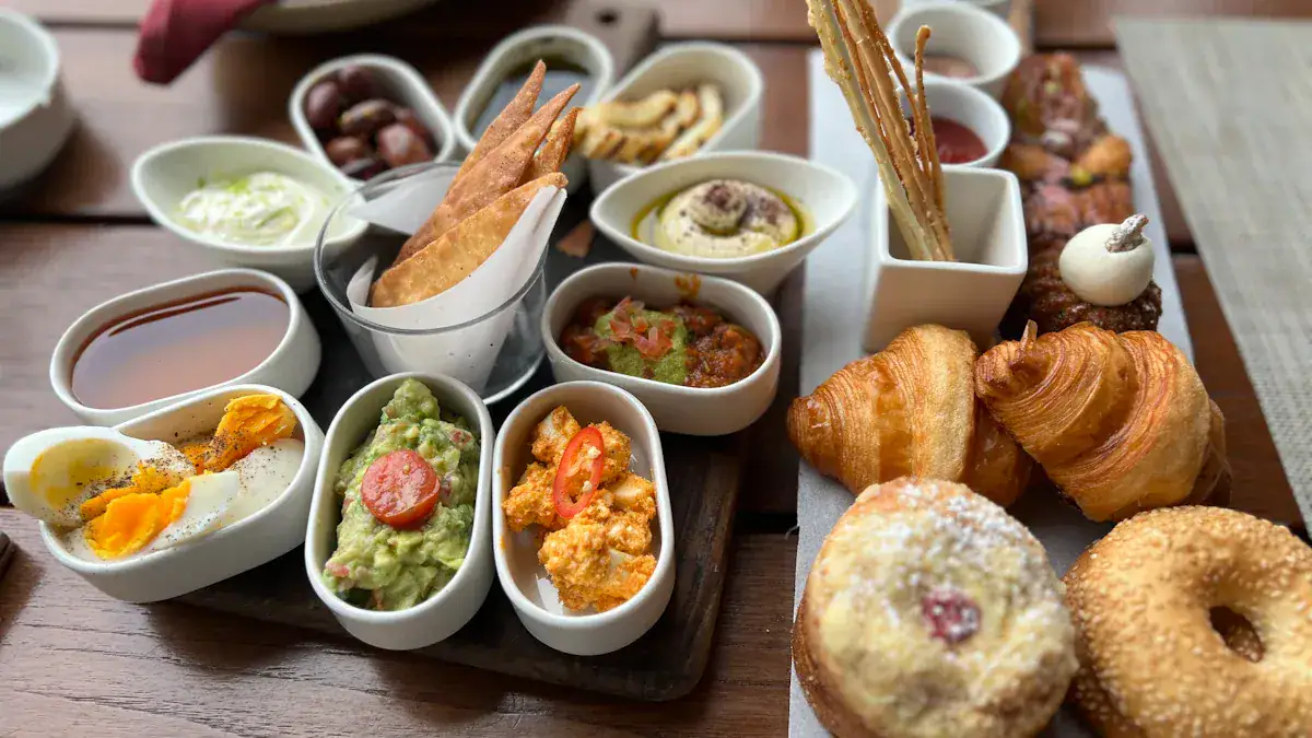 Whether from a bakery or a breakfast spread, the image showcases an assortment of delicious pastries and side dishes arranged on a wooden table, ideal for a hearty breakfast or brunch.