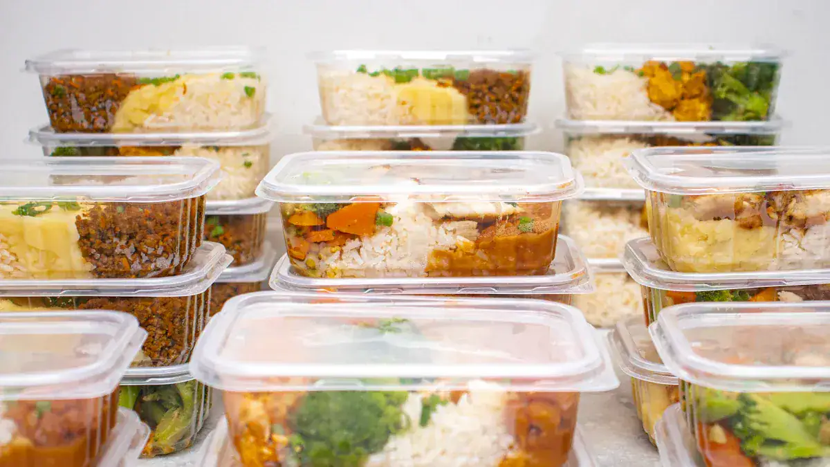 Fresh prepared meal containers with rice, vegetables, and meat for meal prep and takeaway.