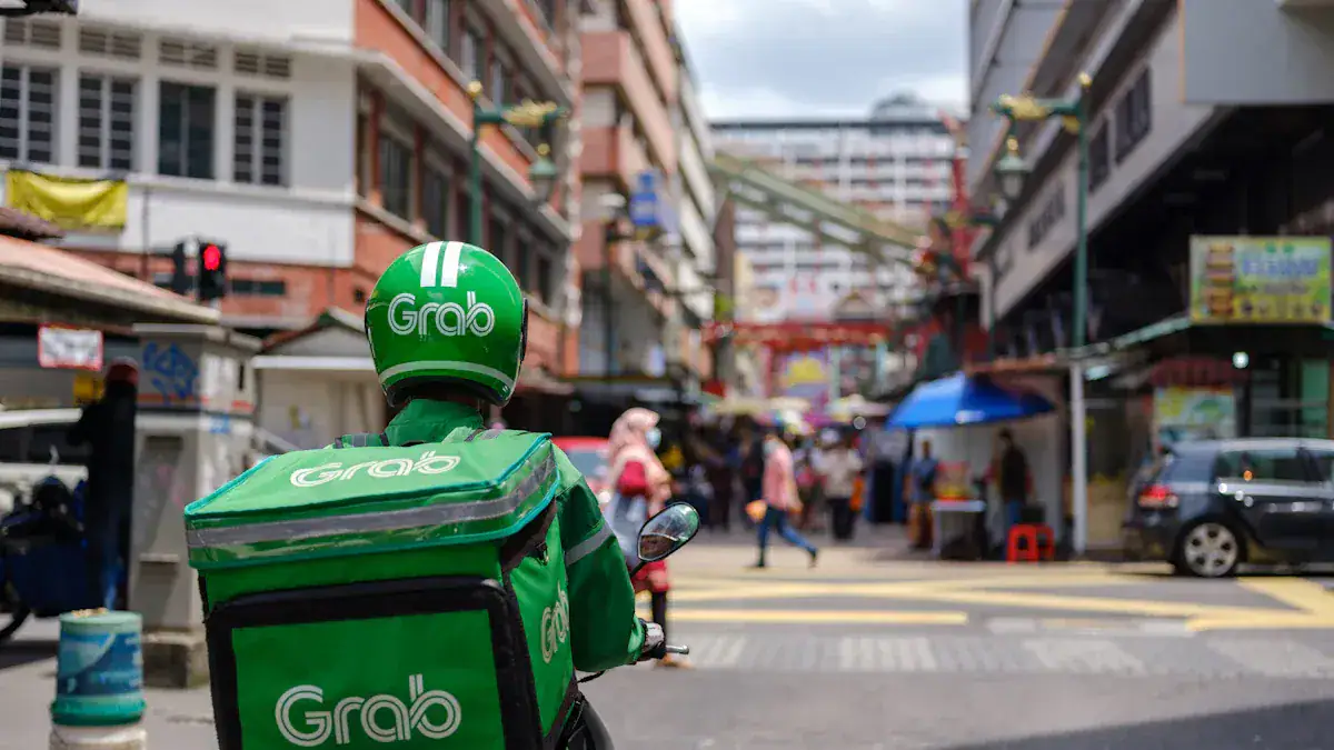 Grab delivery rider wearing green uniform and helmet in busy city street, showcasing custom workwear for delivery services in China, highlighting branded uniforms for food delivery companies.