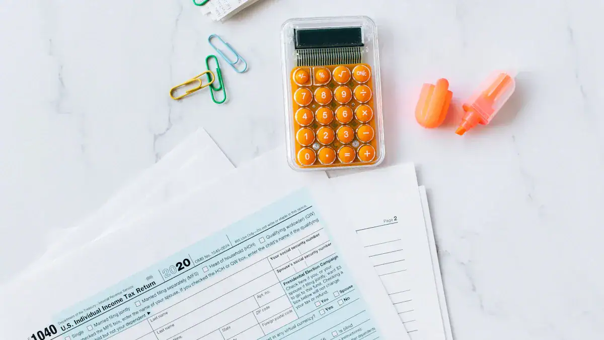 Calculator with orange buttons, paper clips, highlighters, and tax forms on a white surface.