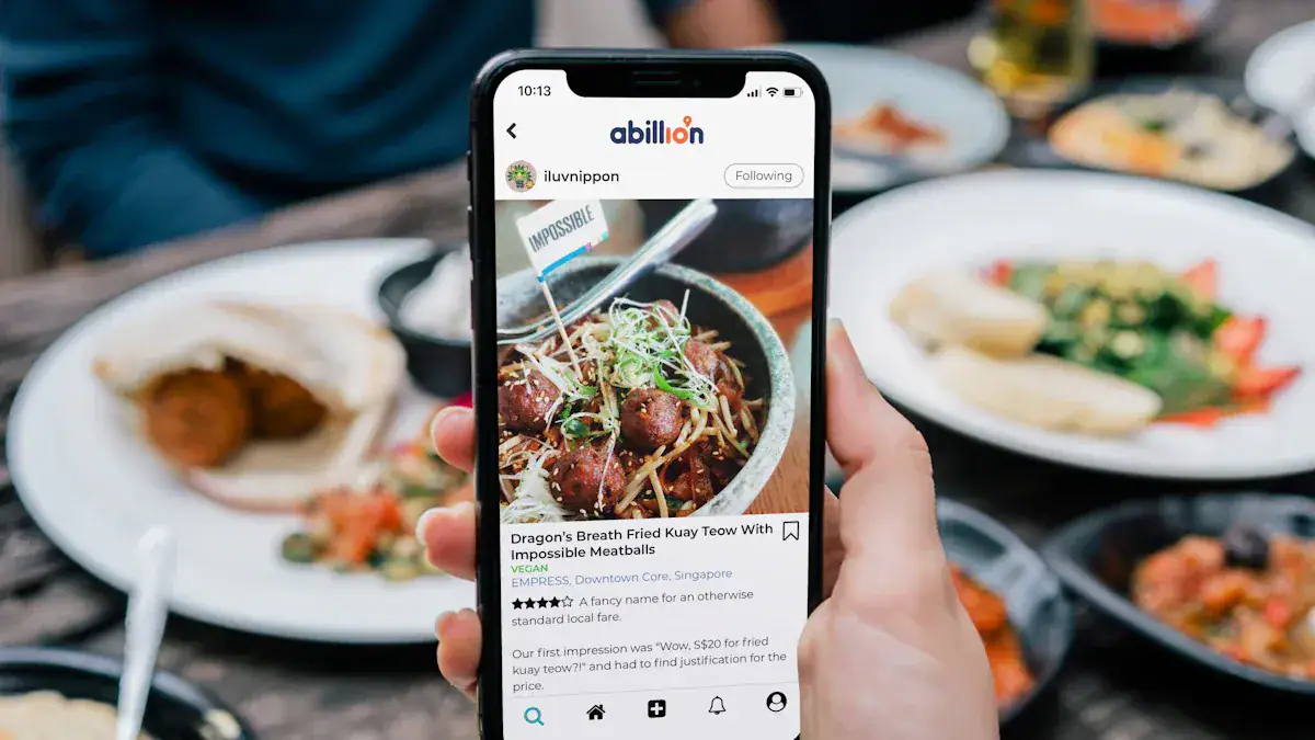 Colorful Asian dishes served on a table with a person holding a smartphone displaying a food review.