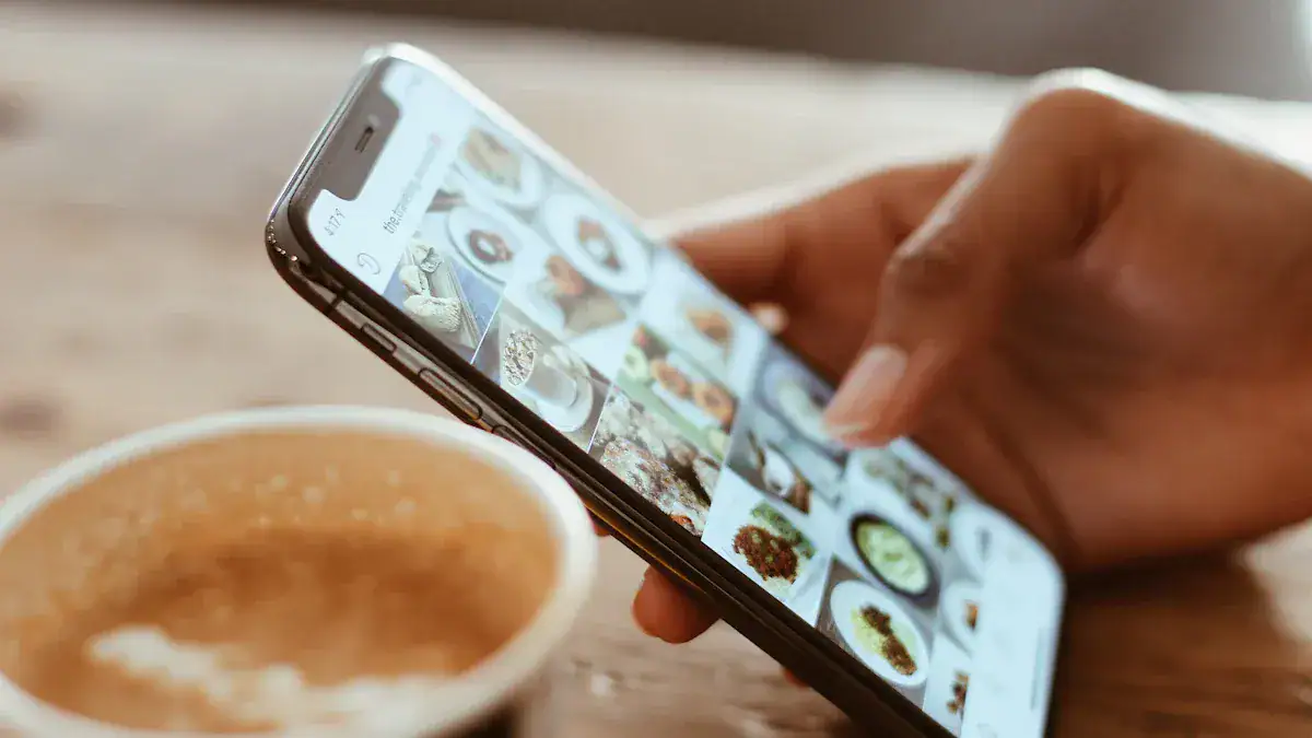 Iphone displaying food photos at a café with a cup of coffee in the foreground.