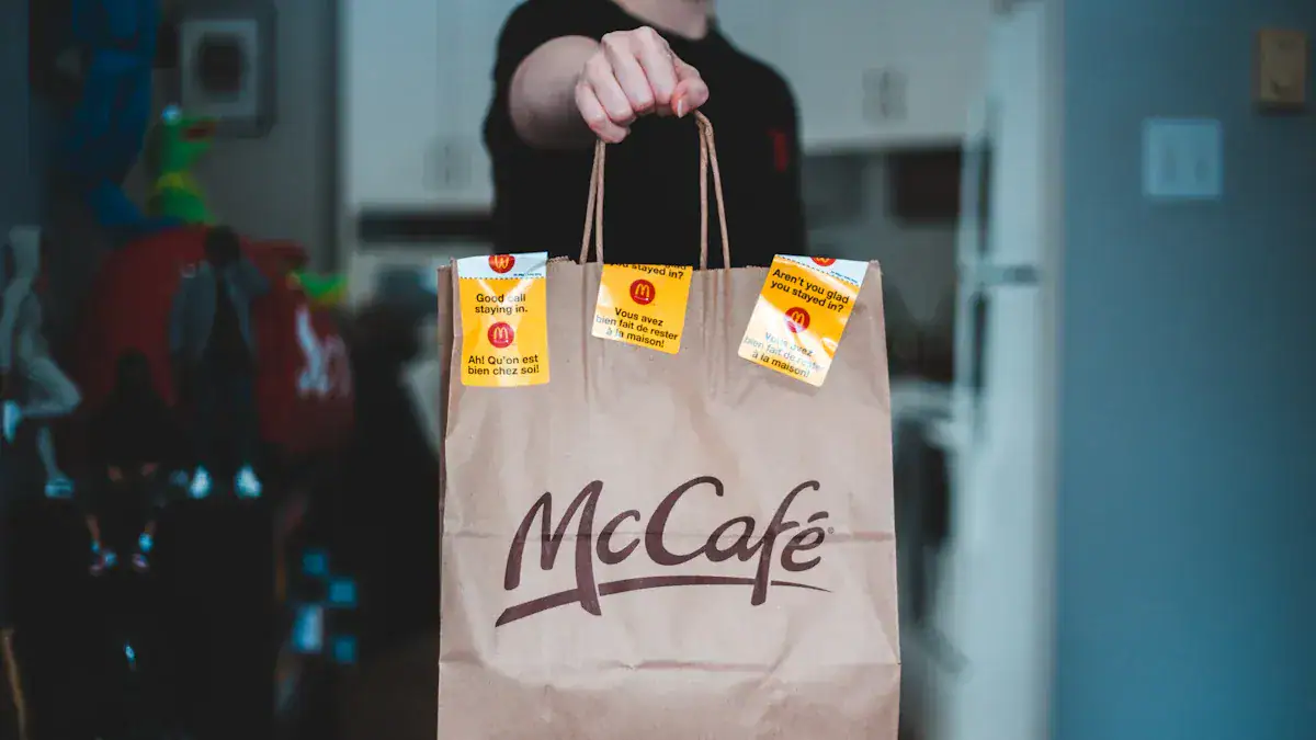 McDonald's paper bag with James and the McDonald's logo, coffee cup, and promotional tags inside.