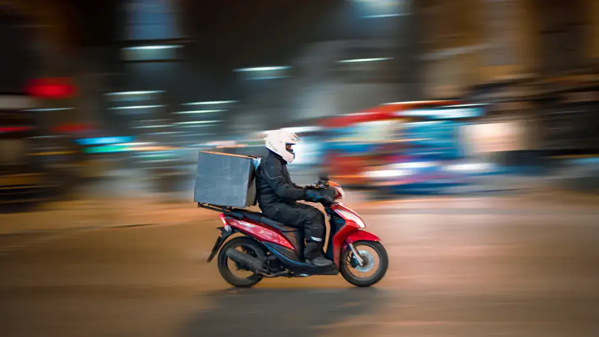 Bike courier riding through city at night, wearing black work uniform and helmet, delivering packages on a red scooter in motion blur, urban logistics and fast delivery concept.