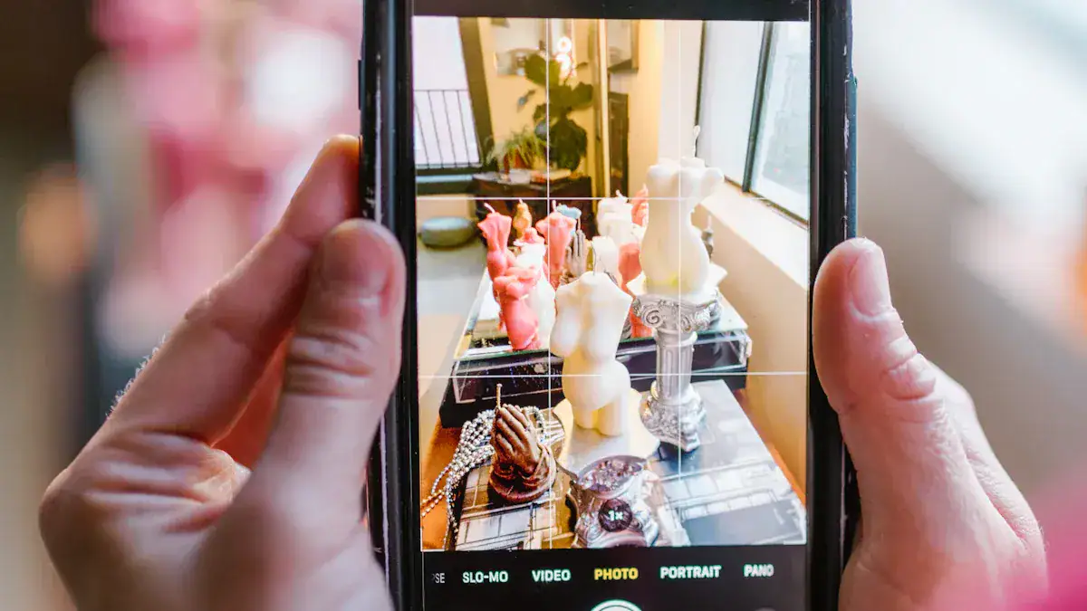 Vivid display of colorful candles and decorative sculptures on a table, captured through a smartphone camera in a well-lit indoor space.