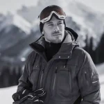 High-performance winter jacket with insulated fabric, suitable for outdoor skiing or snowboarding activities, designed for warmth and durability in cold mountain environments.