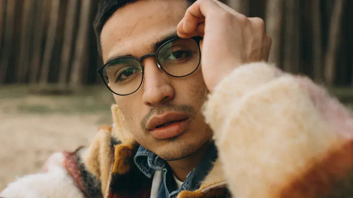 Close-up of a stylish man wearing glasses and a cozy multicolored jacket outdoors, highlighting the quality and fashionable design of custom uniforms from a leading China manufacturer.