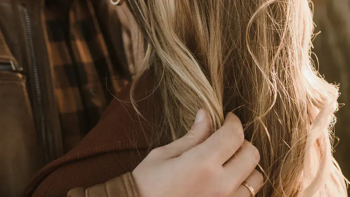 Luxurious brown hair and a hand gently touching the hair, showcasing hair care or beauty service in a warm setting.