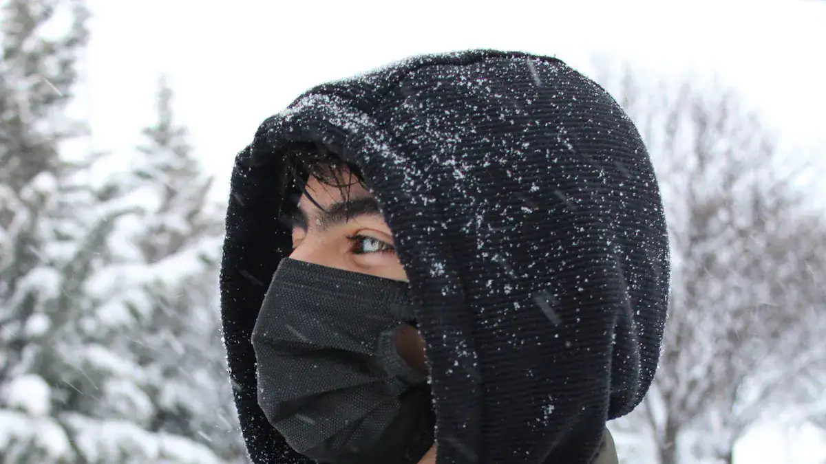 Warm winter clothing with a black hood and face mask for cold weather protection in snowy outdoor environments.