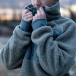 Warm fleece outdoor jacket with high collar, suitable for cold weather activities and workwear.