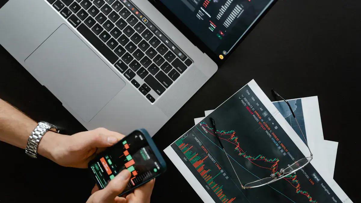 Financial market analysis using a laptop and smartphone with stock charts and data.