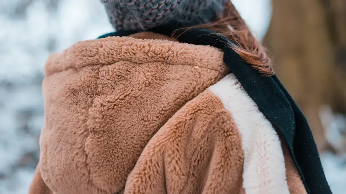 Soft brown fleece jacket with black scarf, warm winter outerwear.