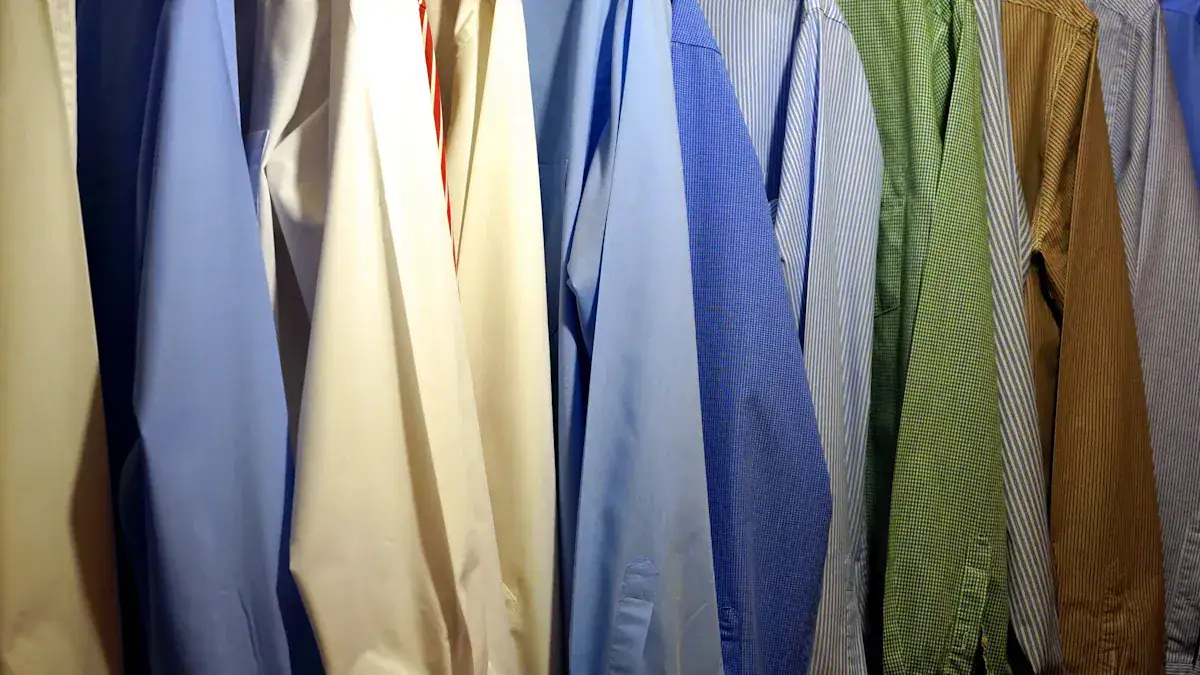 Vast selection of custom dress shirts and uniforms in various colors and fabrics hanging on a clothing rack at a Chinese manufacturer.